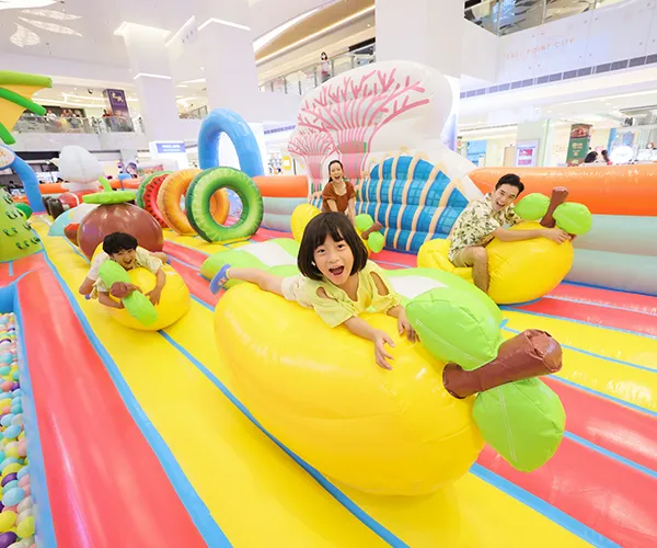 Child bouncing with joy on a bouncy castle
