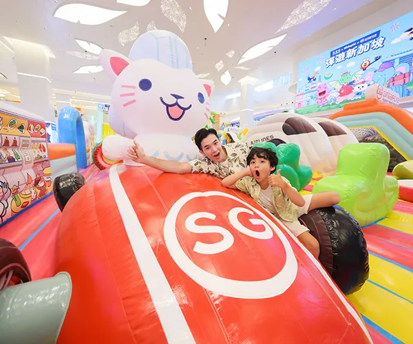 Families having fun at an outdoor inflatable event